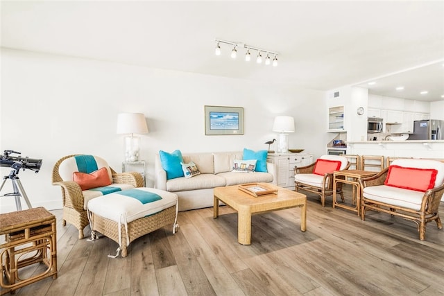 6649 Seacomber Unit 1001, Port Aransas, TX 78373 - living area with light wood finished floors, recessed lighting, and track lighting