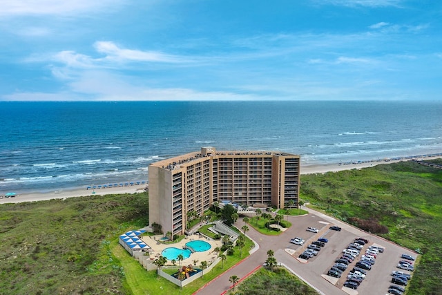 birds eye view of property with a view of the beach and a water view