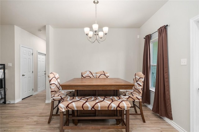 dining space featuring a chandelier and light hardwood / wood-style flooring