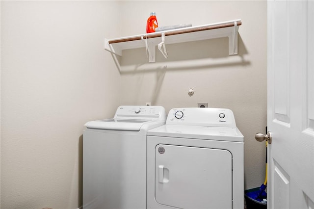 clothes washing area featuring washing machine and clothes dryer