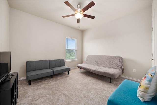 living area with ceiling fan and light colored carpet