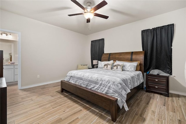 bedroom featuring ceiling fan, light hardwood / wood-style floors, and connected bathroom