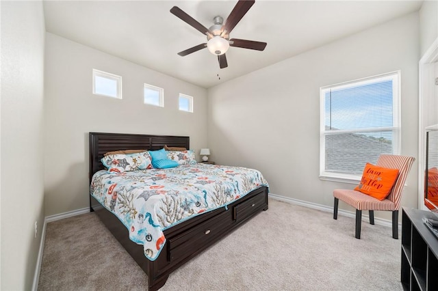 carpeted bedroom featuring ceiling fan and multiple windows