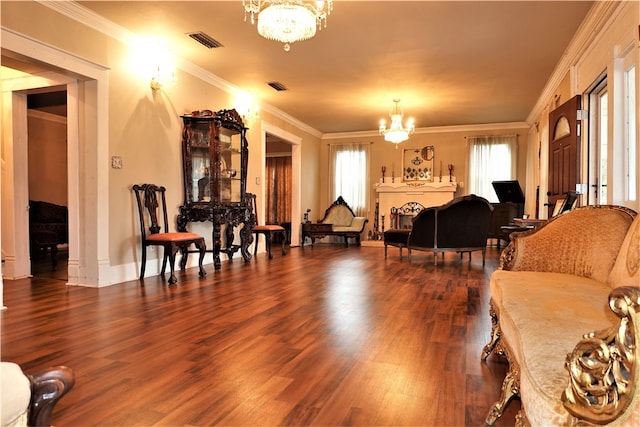 living room with ornamental molding, plenty of natural light, a notable chandelier, and dark hardwood / wood-style flooring