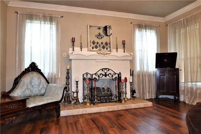 sitting room with hardwood / wood-style floors and crown molding