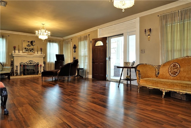 living room featuring wood-type flooring, a notable chandelier, and ornamental molding