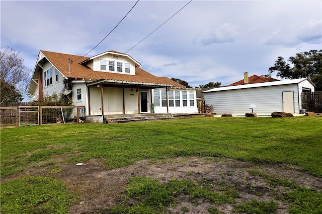 back of house with a lawn