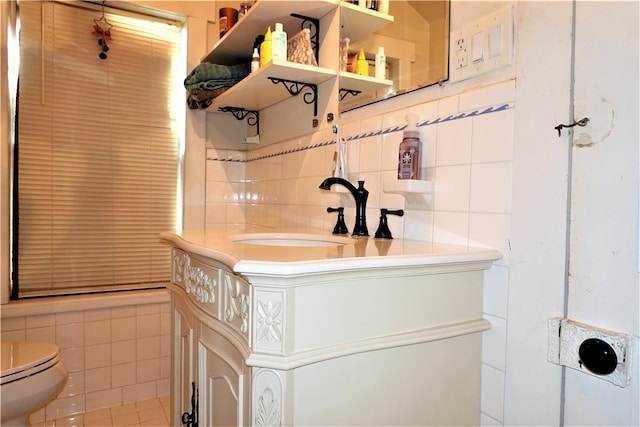 bathroom featuring tile walls, vanity, and toilet