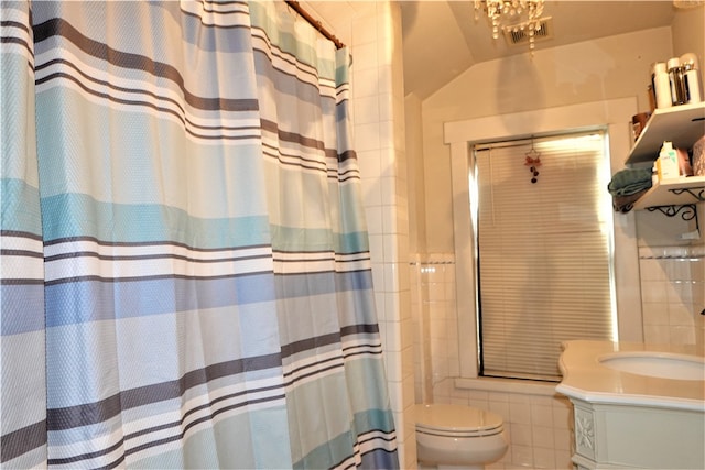 bathroom with toilet, an inviting chandelier, vanity, and a shower with shower curtain