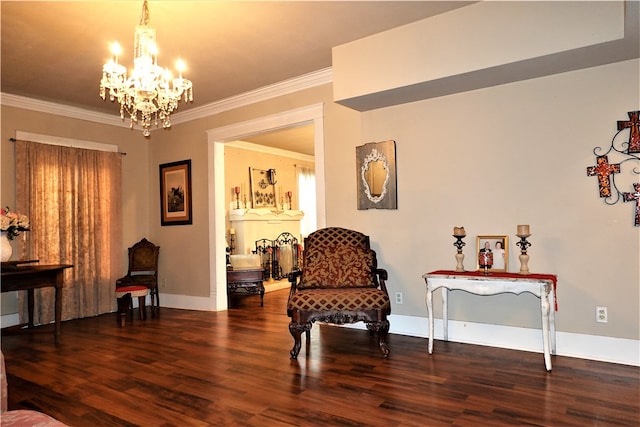 sitting room with a notable chandelier, dark hardwood / wood-style flooring, and ornamental molding