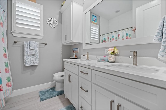 15509 Finistere St, Corpus Christi, TX 78418 - full bath with double vanity, toilet, baseboards, and a sink