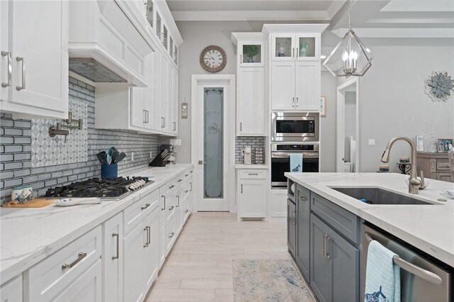 15509 Finistere St, Corpus Christi, TX 78418 - kitchen with gray cabinetry, custom range hood, a sink, white cabinetry, and appliances with stainless steel finishes