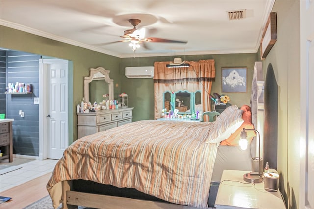 bedroom with ensuite bath, ceiling fan, crown molding, light wood-type flooring, and an AC wall unit