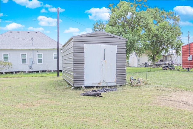 view of outdoor structure with a lawn