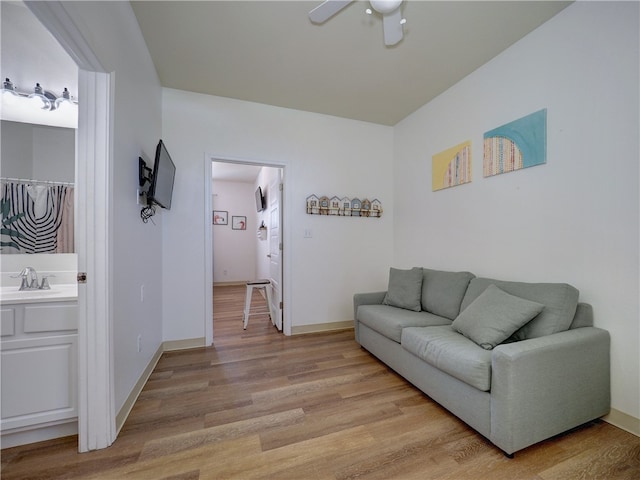 living room with light hardwood / wood-style floors and sink