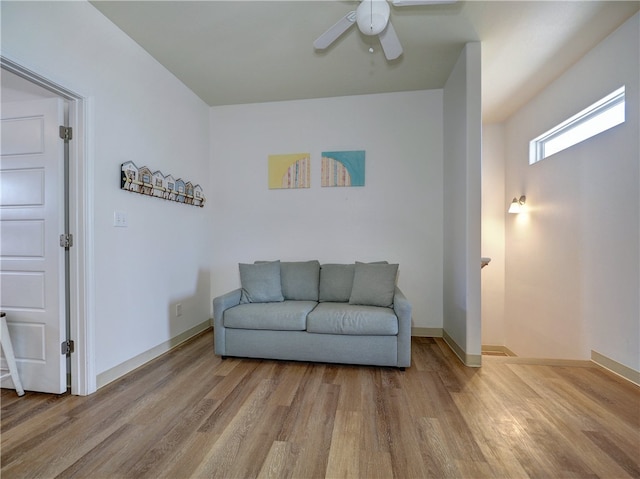 sitting room with ceiling fan and light wood-type flooring