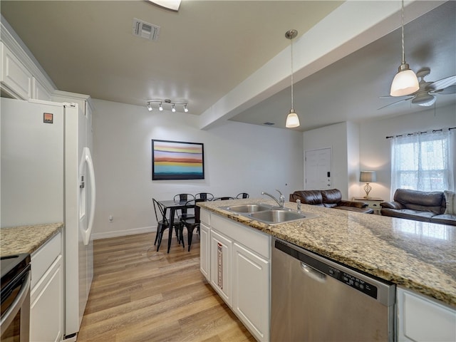 kitchen featuring white cabinets, hanging light fixtures, sink, and dishwasher