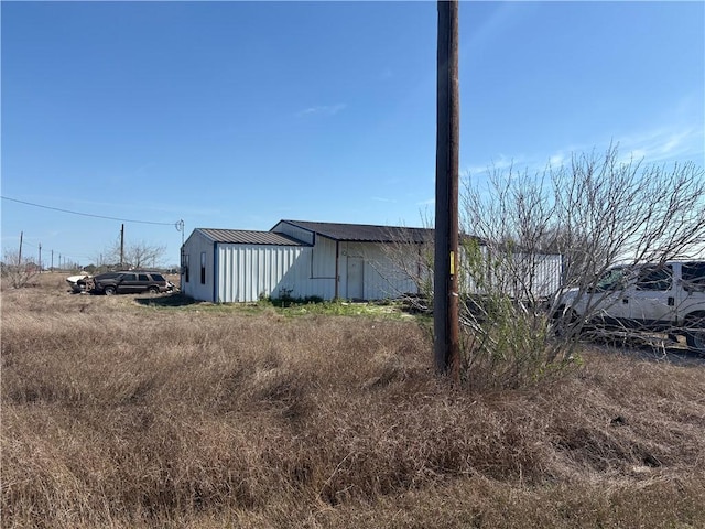 exterior space with a pole building and an outdoor structure