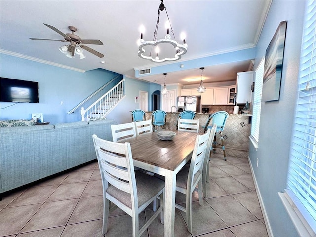 15006 Aruba Dr Unit A, Corpus Christi, TX 78418 - dining room featuring light tile patterned floors, crown molding, plenty of natural light, a ceiling fan, and a chandelier