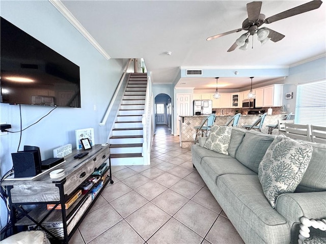 15006 Aruba Dr Unit A, Corpus Christi, TX 78418 - living room featuring ornamental molding, a ceiling fan, arched walkways, stairs, and light tile patterned floors