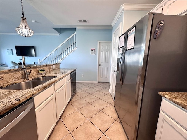 15006 Aruba Dr Unit A, Corpus Christi, TX 78418 - kitchen featuring crown molding, appliances with stainless steel finishes, white cabinets, hanging light fixtures, and light tile patterned floors