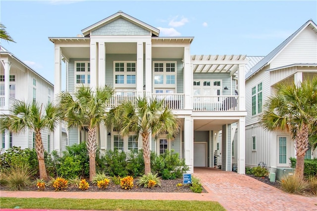 view of front of home featuring a carport and a balcony