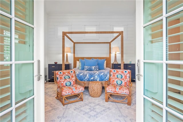 bedroom featuring wooden walls