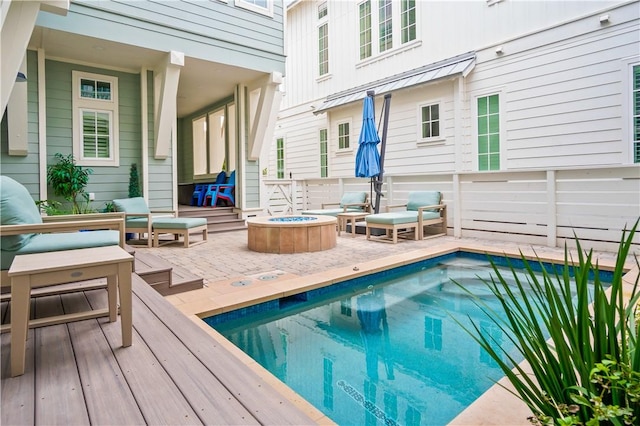 rear view of property featuring an outdoor fire pit