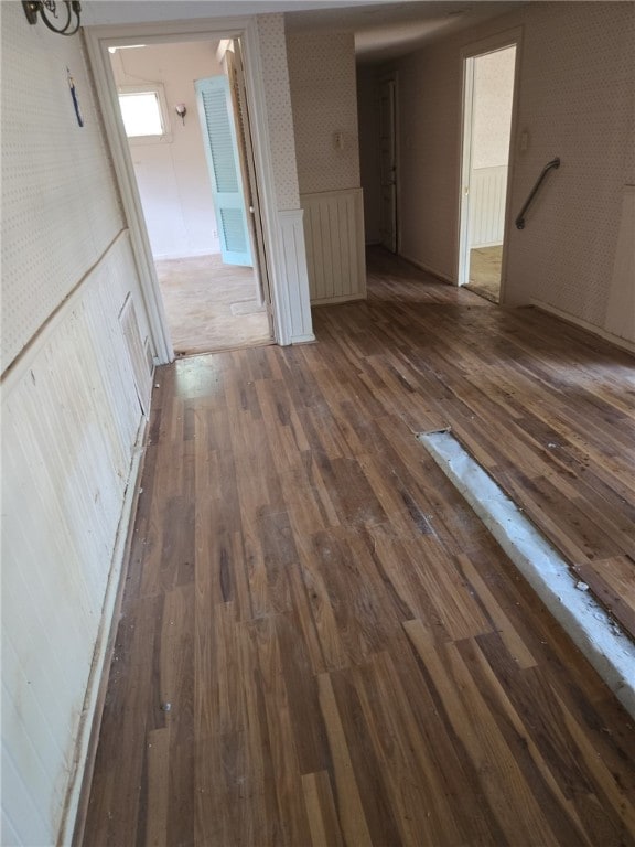 306 S Hall St, Beeville, TX 78102 - empty room featuring dark wood-type flooring, a wainscoted wall, and wallpapered walls