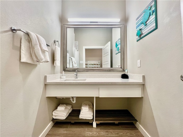 bathroom featuring wood-type flooring and sink