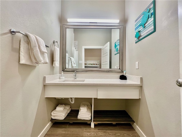 bathroom with sink and hardwood / wood-style flooring