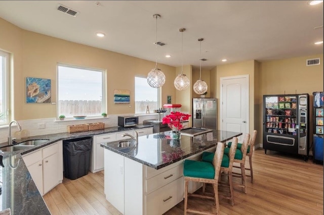 kitchen featuring white cabinetry, a healthy amount of sunlight, and a kitchen island