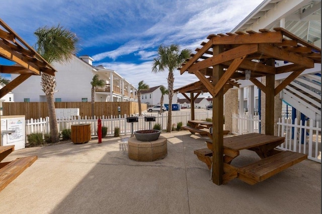 view of patio / terrace with a fire pit and a pergola