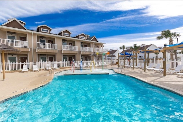 view of swimming pool featuring a patio and pool water feature