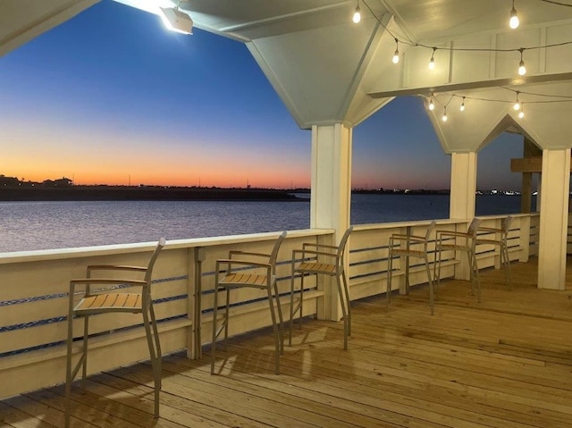 deck at dusk with a bar and a water view