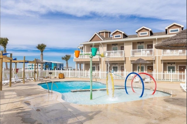 view of swimming pool with pool water feature