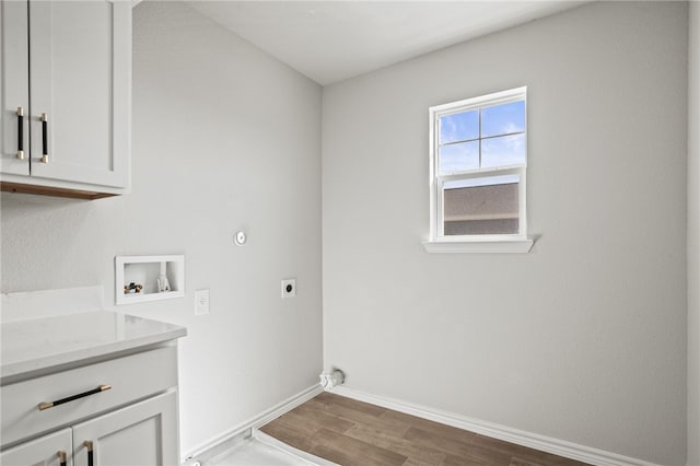 laundry room with wood finished floors, baseboards, hookup for an electric dryer, cabinet space, and washer hookup