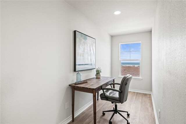 home office featuring baseboards and light wood-style floors