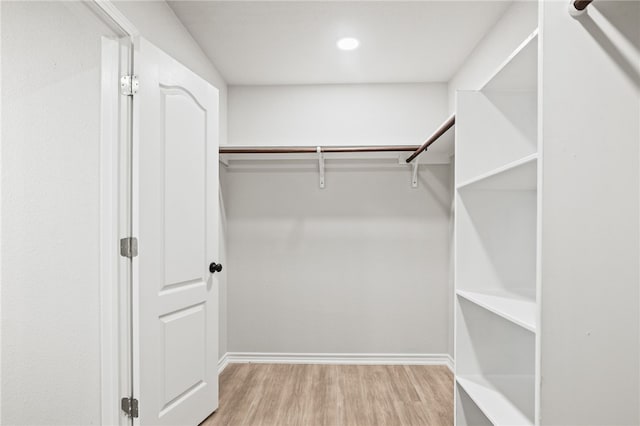 walk in closet featuring wood finished floors