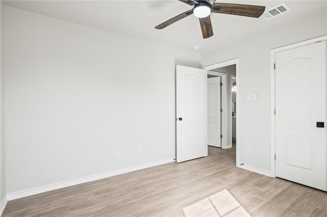 unfurnished bedroom with a ceiling fan, light wood-style floors, visible vents, and baseboards