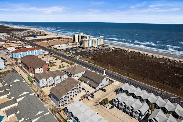 bird's eye view with a water view and a beach view