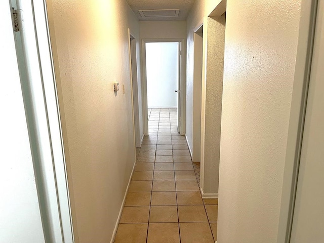 1403 Kingfisher Dr, Beeville, TX 78102 - hallway with light tile patterned flooring and a textured wall