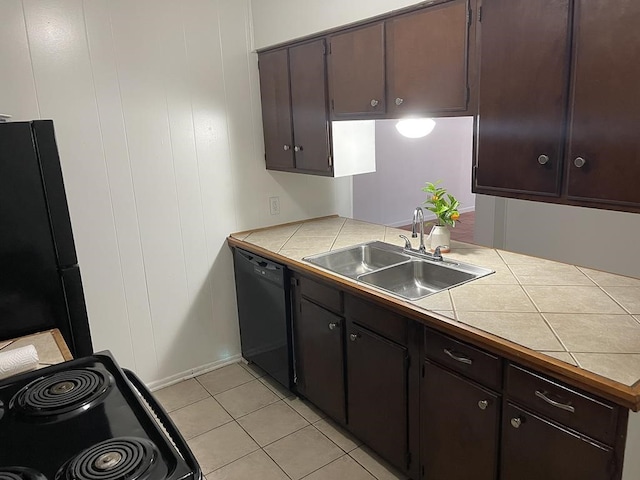 1403 Kingfisher Dr, Beeville, TX 78102 - kitchen featuring black appliances, tile counters, light tile patterned floors, and dark brown cabinets