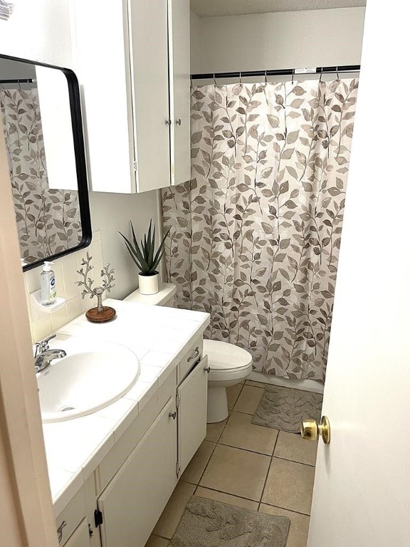 1403 Kingfisher Dr, Beeville, TX 78102 - bathroom featuring vanity, tile patterned floors, and curtained shower