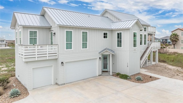 view of front facade featuring a standing seam roof, metal roof, and stairway