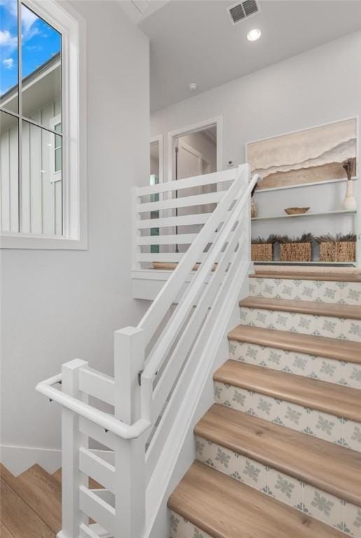 stairs featuring recessed lighting, wood finished floors, visible vents, and baseboards