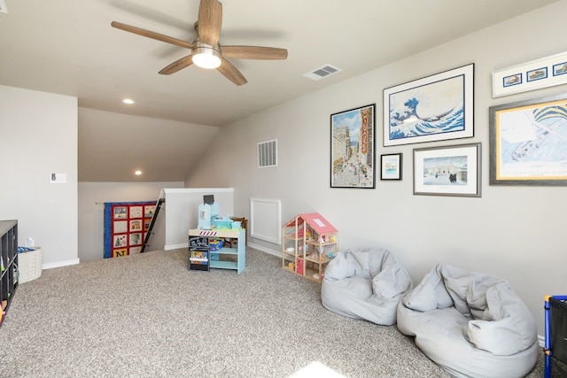 playroom with visible vents, carpet floors, ceiling fan, and vaulted ceiling