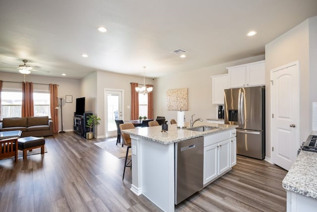 kitchen with dark wood-style floors, visible vents, open floor plan, and stainless steel appliances