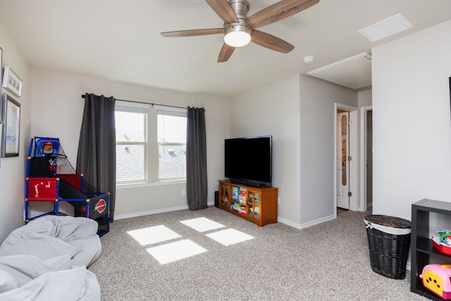 carpeted living room with a ceiling fan and baseboards