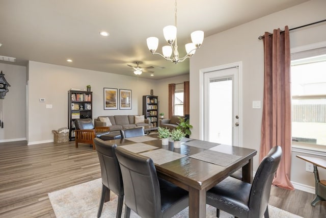 dining room featuring ceiling fan with notable chandelier, light wood-style flooring, recessed lighting, and baseboards